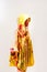 beautiful woman in raincoat painted with yellow and red paints standing in hood