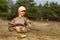 Beautiful woman ranger with rifle in camouflage