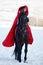 Beautiful woman with red cloak with horse outdoor