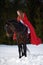 Beautiful woman with red cloak with horse outdoor
