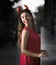 Beautiful woman in red dress and horns. Halloween