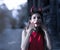 Beautiful woman in red dress and horns. Halloween