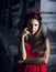 Beautiful woman in red dress and horns. Halloween