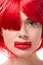 beautiful woman with red hair and red lips in shape of rectangle looking at camera