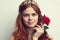 beautiful woman with red hair red rose flower close up