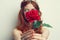 beautiful woman with red hair red rose flower close up