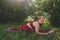 Beautiful woman in red leggings and a top practicing yoga in a city park