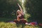 Beautiful woman in red leggings and a top practicing yoga in a city park