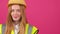 Beautiful woman in reflective vest, yellow hardhat and jacket looking at the camera.