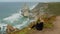 Beautiful woman relaxes at Cabo da Roca in Portugal - Sintra Natural Park