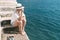 Beautiful woman relaxing on beach. Azure blue sea. Summer vacation. Straw hat. Young girl enjoys summer holiday.