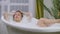 Beautiful woman relaxing in bubble bath lying in bathtub. Beauty care, leisure activity and healthcare concept