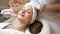 Beautiful woman relaxing during non-invasive facial treatment for rejuvenation