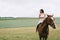 beautiful woman riding brown horse