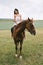 beautiful woman riding brown horse