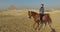 Beautiful woman riding horse at Giza pyramids complex