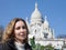 Beautiful woman with a rose before Basilica of Sacre-Coeur, Montmartre. Paris.