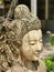 Beautiful woman`s face from a stone statue in northern Thailand.