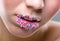 Beautiful woman\'s mouth full of colorful candies