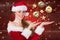 Beautiful woman in santa costume pretending to hold imaginary christmas decoration