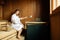 Beautiful woman in sauna pouring oils on hot stones