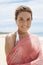 Beautiful Woman With Scarf Standing On Beach