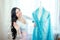 Beautiful woman seamstress with long dark hair drapes the fabric on mannequin . the tailor chooses the color of the