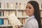 Beautiful woman shopping for books at the store