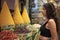 Beautiful woman shopping in a spice store and enjoying the spices in the Jemaa el Fna square in the city of Marrakech in Morocco