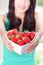 Beautiful woman showing fresh strawberries