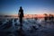 Beautiful Woman Silhouette posing near Sea. Seashore sunset