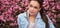 Beautiful woman sitting on flowers in the park