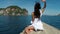 Beautiful woman sitting on Thailand boat nose in sea back rear view action camera pov, young girl in white