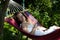 Beautiful woman sleep in hammock. summer holiday and vacation. sexy girl relax in hammock. female wear white romantic dress and