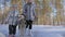 Beautiful woman and small child walking in winter forest with of husky dog. Happy young mother with daughter in the