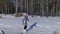 Beautiful woman and small child walking in winter forest with of husky dog. Happy young mother with daughter in the