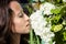 Beautiful woman smell hydrangea flowers. white hydrangea blossom. spring blooming garden. beauty and health. concept of organic