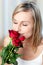 Beautiful woman smelling roses