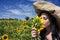Beautiful woman smelling sunflower