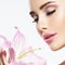 Beautiful woman smells flower. skin care beauty