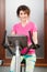 Beautiful woman smiling and using stationary bicycle