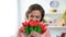 Beautiful woman sniffing red tulips, present from boyfriend, holiday celebration