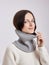 Beautiful woman in a Snood scarf on a white background. Autumn warm clothing