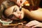 Beautiful woman in spa salon having chocolate therapy procedure