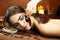 Beautiful woman in spa salon having chocolate therapy procedure