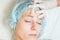 Beautiful woman in spa salon receiving epilation or correction eyebrow