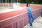 Beautiful woman in the stadium. Portrait of a fitness woman resting at outdoor stadium