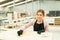 Beautiful woman staining a wood cabinet with a sponge