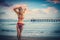 Beautiful woman standing on the beach, enjoying the holiday.