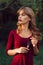 Beautiful woman standing with feather in forest